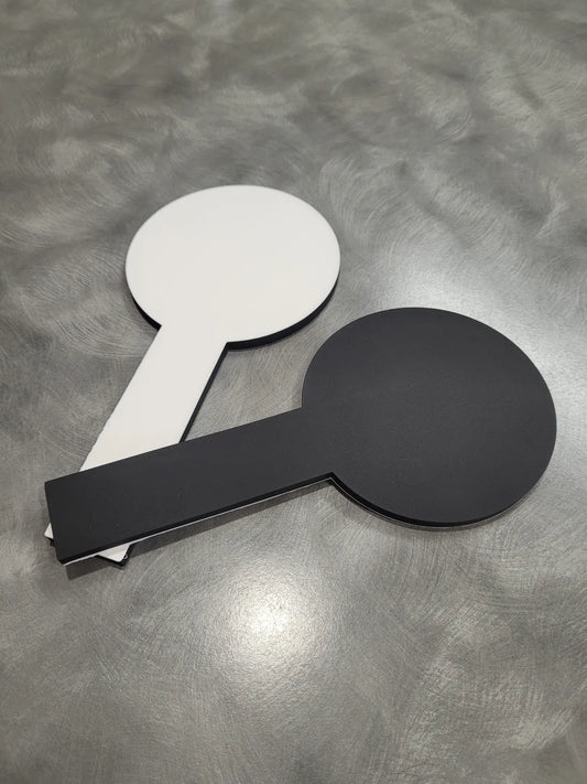 two easy find coasters one white side up and one black side up. with grey background